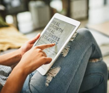 Closeup shot of an unrecognisable woman using a digital tablet at home